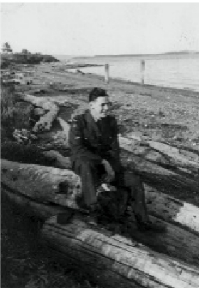Bruno, Comox 1944. Elizabeth wrote on the photo: Haven’t I got a lovely husband. I get crazier about him every day. This is on our little beach in Sidney. The tide is out a little when it’s in the water comes right up to the logs